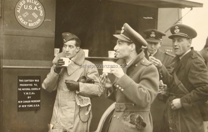 Peter Provenzano Photo Album Image_copy_021.jpg - The 71st Eagle Squadron taking a break from training at the YMCA canteen truck.  Peter Provenzano is second from the left and at the forefront.  RAF Station Sealand, October 1940.